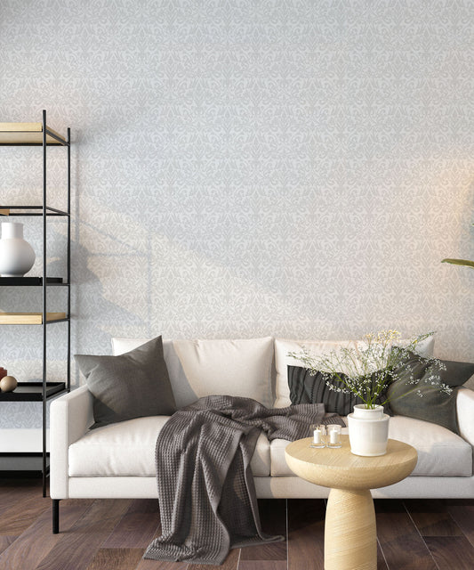 Modern living room with a white sofa, decorative pillows, and a patterned wall.